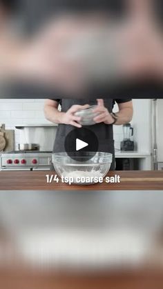 a person standing in front of a counter with a bowl on it and the words 1 / 4 topperress salt