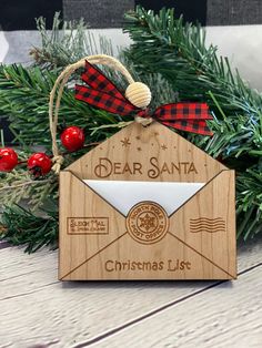 a wooden ornament with an envelope on it