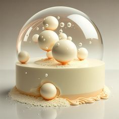 there is a snow globe with bubbles in it on top of a cake stand,