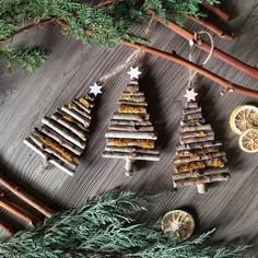 christmas tree made out of sticks and lemons on a table with cinnamon stick decorations