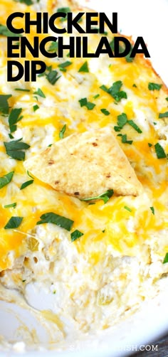 chicken enchilada dip in a white casserole dish with tortilla chips