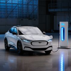 an electric car plugged in to a charging station with blue light coming from it