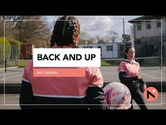 two girls in pink jackets are playing with a ball on the court and back and up