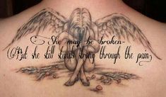 an angel tattoo on the back of a woman