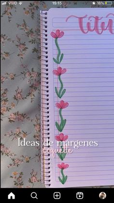 an open notebook with pink flowers on it