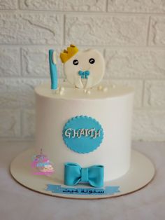 a white cake with blue decorations on it