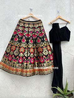 Black Banarasi Lehenga Choli For Women India Wedding Party Wear Ghagra Choli Bridesmaids Engagement Lengha Choli Traditional Lahenga For Her Lehenga (Semi-Stitched) Fabric: Banarasi Silk  Work : Zari Weaving   Inner: Micro Cotton with can-can layered net. Size  : waist-42"Length-42" Blouse (Unstitched) Fabric: Georgette Work: Plain  Size: up to 42" Dupatta - Attached With Blouse Package Contains: 1 Semi-Stitched Lehenga with Dupatta and Unstitched Blouse What is semi stitched Product? Semi stitc Party Brocade Lehenga With Dupatta, Party Brocade Lehenga With Traditional Drape, Party Lehenga With Traditional Drape In Brocade, Brocade Choli For Eid Party, Black Art Silk Lehenga For Party, Anarkali Brocade Choli For Parties, Party Brocade Choli With Cutdana, Party Anarkali Choli In Brocade, Floor-length Art Silk Choli For Celebrations