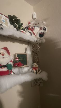 santa clause and other christmas decorations on shelves