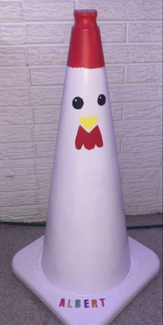 a white and red plastic cone shaped like a chicken