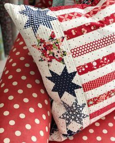 red, white and blue pillows with stars on them