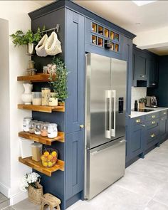 a kitchen with blue cabinets and shelves filled with food