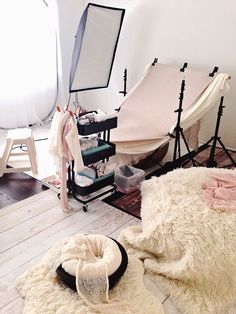 an image of a bedroom setting with white fur on the floor and other furniture in the background