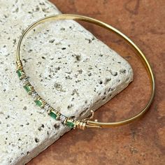 Estate/ vintage 14KT yellow gold genuine, marquise emerald and diamond bangle bracelet. Measures: 7” Weight: 4.70 grams Links width: 2.5mm (5) marquise emeralds (4) Diamonds tiny Easy to use push in clamp clasp with safety Stamped + Hallmarked Yellow Gold Emerald Bangle Bracelet, Yellow Gold Emerald Bangle Bracelets, Yellow Gold Emerald Bangle, Fine Jewelry Green Bangle For Anniversary, Heirloom Marquise Emerald Jewelry, Green Fine Jewelry Bangle For Anniversary, Classic Green Bangle Jewelry, Heirloom Style Marquise May Birthstone Jewelry, Heirloom Marquise May Birthstone Jewelry