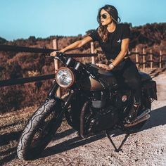 a woman sitting on top of a motorcycle