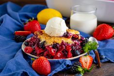 a piece of pie on a plate with berries and ice cream