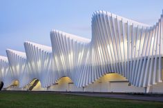 an architecturally designed building is lit up at night