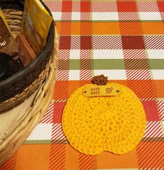 a basket that has some food in it on top of a checkered table cloth