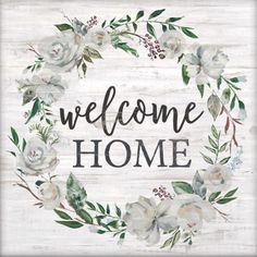 a welcome sign with white flowers and greenery in the center that says, welcome home