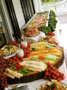 an assortment of fruits and vegetables on a buffet table