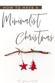 the cover of how to have a minimalist christmas, with red stars hanging from branches