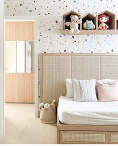 a bedroom with white walls and colorful confetti on the wall