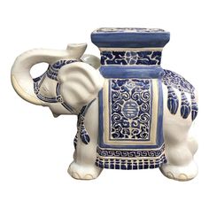 an elephant figurine with blue and white designs on it's trunk, sitting in front of a white background