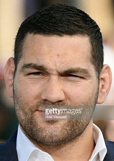 a close up of a man wearing a suit and white shirt with his eyes closed