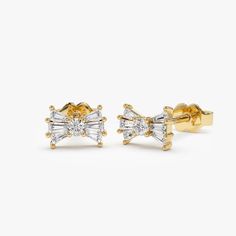 Diamond Studs / 14k Gold Baguette and Round Diamond Bow Stud Earrings / Dainty Diamond Earrings / Minimalist Diamond Earrings by Ferkos Fine Jewelry Features * Gold Kt: 14K Gold (Please message me if you want 18K) * Available Gold Color: Rose Gold, Yellow Gold, White Gold *  Length: 6.8 MM *  Height: 5 MM *  Round Diamond: 2 Pcs 2.0 MM *  Round Diamond: 12 Pcs 2.4 x 1.35 MM * Total CTW: 0.25 CTW  * Diamond Color-Clarity: G Color VS Clarity ▶ See more of our Diamond Earrings - http://etsy.me/2lyqVBP ▶ See our storefront here - http://etsy.me/2lUcVnH  ▶ All store sections here * Diamond Rings - http://etsy.me/2lwKUl8 * Diamond Earrings - http://etsy.me/2lyqVBP * Diamond Necklace - http://etsy.me/2mqa6O1 * Diamond Bracelets - http://etsy.me/2mVrAB5 * Diamond Wedding Rings - https://etsy.me/3Y Classic Gold Diamond Earrings With Baguette Diamonds, Classic Gold Diamond Earrings With Baguettes, Classic Gold Baguette Diamond Earrings, Elegant Gold Baguette-cut Earrings, Elegant Gold Baguette Cut Earrings, Elegant Baguette Cut Gold Earrings, Formal Yellow Gold Earrings With Baguette Diamonds, Timeless Yellow Gold Earrings With Baguette Diamonds, Yellow Gold Baguette Cut Earrings For Anniversary