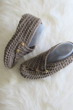 a pair of slippers sitting on top of a white fur covered floor