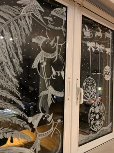 the window is decorated with frosting and christmas decorations