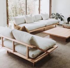 a living room filled with furniture and large windows