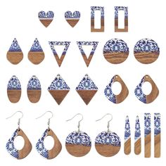 wooden earrings and earring sets with blue designs on them, all in different shapes