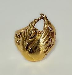 Art Nouveau c1930s This beautifully made Nouveau era ring, with a few Victorian elements - a fine example of transitional design. The details I. The Swan are fluid and very pretty. The scroll work is clearly hand wrought. An elegant piece. 5.6g 14k solid yellow gold Hallmarked Swan measures 19 x 13mm Shank tapers from 9mm to 3mm S 6.5 US resizable Very fine antique condition Gold Art Deco Rings With Intricate Design, Art Nouveau Gold Engraved Rings, Art Nouveau Style Gold Engraved Rings, Art Nouveau Style Engraved Gold Rings, Art Nouveau Engraved Yellow Gold Ring, Art Nouveau Yellow Gold Collectible Rings, Collectible Art Nouveau Yellow Gold Ring, Art Nouveau Yellow Gold Round Ring, Gold Art Nouveau Ring For Formal Occasion