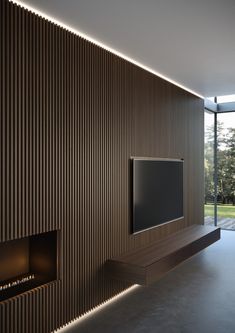 a living room with a flat screen tv mounted on the wall next to a fire place