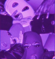 a group of people wearing masks in front of a purple background