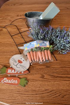 carrots and lavender flowers on a wooden table with an easter bunny cutout next to it