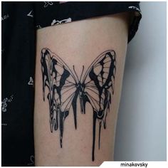 a black and white butterfly tattoo on the right side of the thigh, with dripping paint all over it