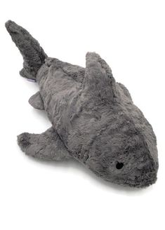 a gray stuffed shark laying on the ground