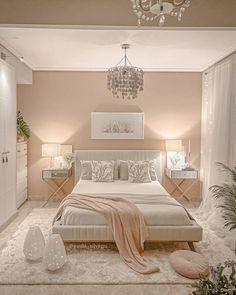 a bedroom with pink walls and white furniture