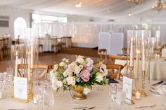 a table set up with flowers and candles for an elegant wedding reception at the grand america hotel