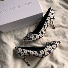 New, In Box. Size 39 With A Fondness For Accessories, Spanish Designer Manolo Blahnik Manolo Blahnik Sourced A Buckle In Italy That Was Used To Create The Glittering Embellishment On His Signature Hangisi Courts. They’re Part Of The Maison’s Storied Heritage That Dates Back To The 70s, When He First Started Redefining Stiletto Heels. This New-Season Linen Pair Comes Covered In A Floral Print Evocative Of The Roses That Appear In Director Pedro Almodvar’s 'La Flor De Mi Secreto' And 'Volver' Film Manolo Blahnik Maysale, Back To The 70s, Manolo Blahnik Pumps, Leather Jewels, Manolo Blahnik Black, Manolo Blahnik Hangisi, Jeweled Shoes, Manolo Blahnik Heels, Crystal Sandals