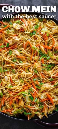 chow mein noodles with carrots, chicken and green onions in a black skillet