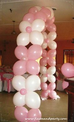 the balloon arch is decorated with pink and white balloons