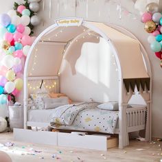 a child's bedroom with balloons and streamers all around the room, including a canopy bed