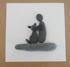 an image of a rock sculpture with a dog and cat sitting on top of it