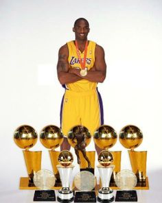 the basketball player is posing with his trophies