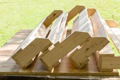 several pieces of wood sitting on top of a wooden pallet in the shape of letters