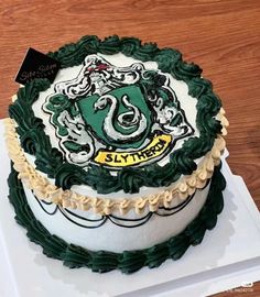 a harry potter themed cake on top of a white plate with gold trimmings