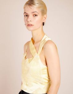 Pale Yellow asymmetric tulle and silk topFastens with chunky zip at central back and invisible snap fasteners at neck/bust on left hand sideComposition: Body: 100% Silk / Tulle: 100% Pes / Lace: 75% Lurex 25% NylonDry Clean OnlyFit and Model SizeModel wears UK size 6 and is 5'8'' (172 cm) Fits true to size, however those who are between sizes should take the larger size Light weight fabric, non stretch Designed to be fitted