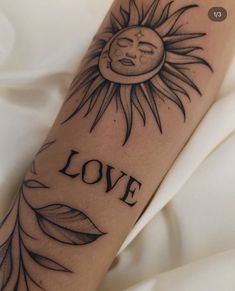 a tattoo with the word love written on it and a sun in the middle, surrounded by leaves